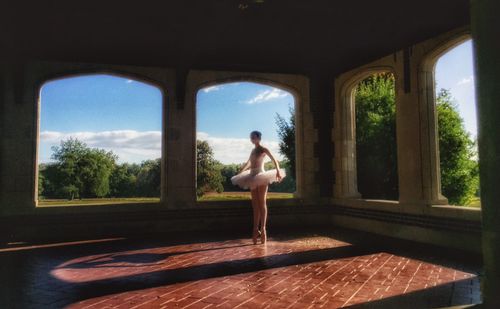 Woman standing by window