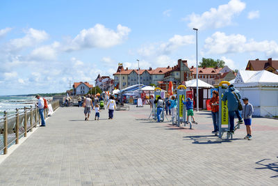 People on beach against sky