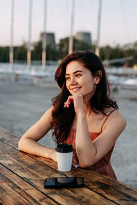 Portrait of young woman sitting outdoors