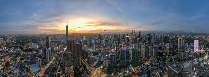 Aerial view of cityscape against sky during sunset