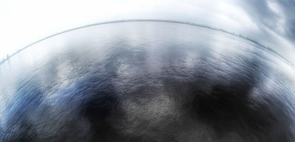 Close-up of water on metal against sky