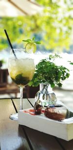 Close-up of drink on table by the beach