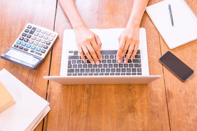 High angle view of woman using laptop on table