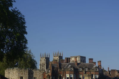 Low angle view of buildings against clear blue sky