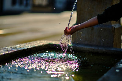 Close-up of person hand in water