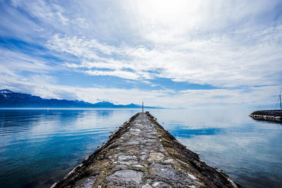 Scenic view of lake against cloudy sky