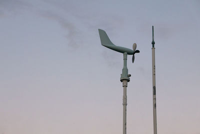 Low angle view of telephone pole against sky