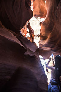 Woman photographing at antelope canyon