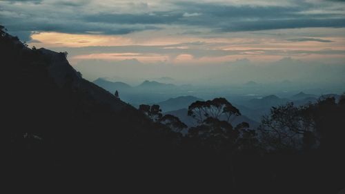 Scenic view of silhouette mountains against sky at sunset