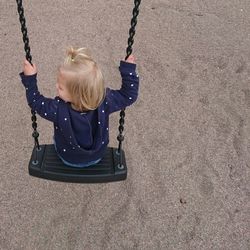 Close-up of girl in swing