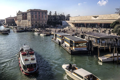 Boats in river with buildings in background