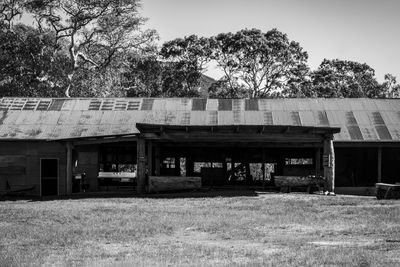 Abandoned house on field against sky