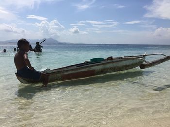 Man on sea shore against sky