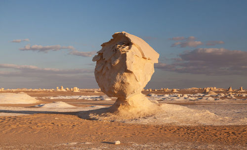 View of rocks on land against sky