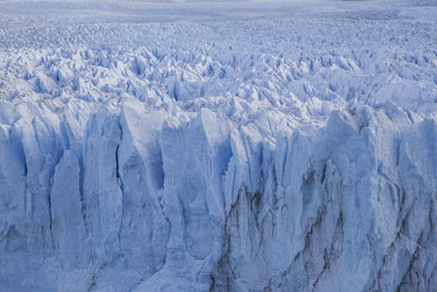 Close up of glacier perito moreno argentina with unique shapes and pattern into sunlight