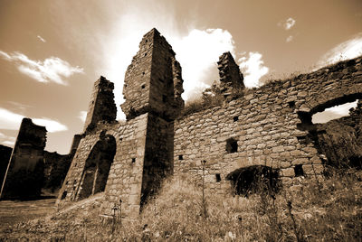 Low angle view of old ruin against sky