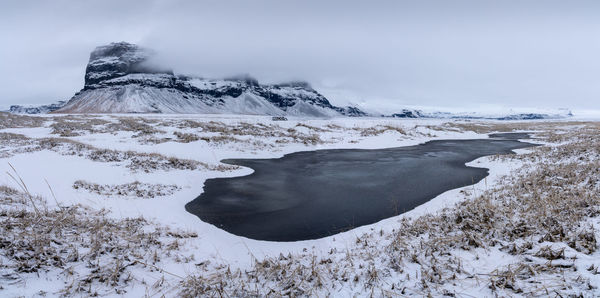 Scenic view of snow covered mountain against sky