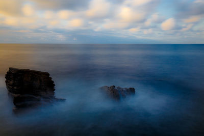 Scenic view of sea against cloudy sky