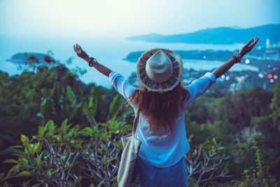 Midsection of woman with arms raised