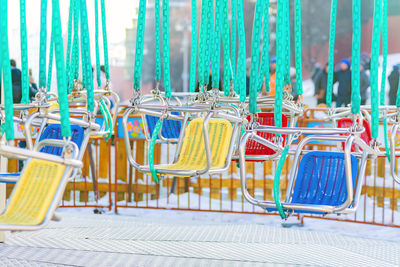 Close-up of empty chairs on carousel 