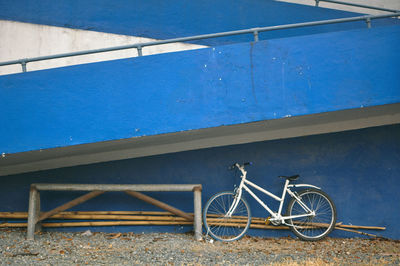 Bicycle parked below steps