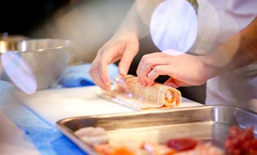 Midsection of man preparing food on table