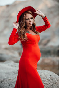 Portrait of beautiful young woman standing outdoors