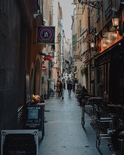 People on street amidst buildings in city