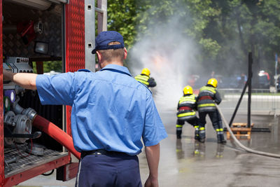 Rear view of people working in city