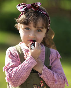 Portrait of cute girl standing outdoors