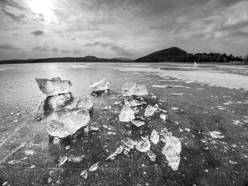 Ice fragments on frozen lake water level. the ice broken into shinning jagged pieces. backlight