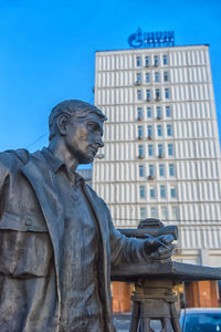 Low angle view of statue against building