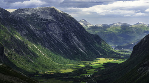 A photo taken from a vantage point that looks out over the valley called trollstigen in norway.