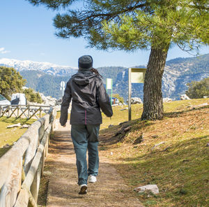 Full length rear view of man walking outdoors