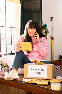 Portrait of young woman sitting at home