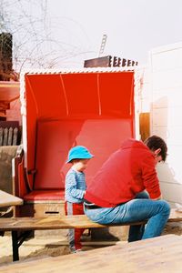 Rear view of people sitting outdoors