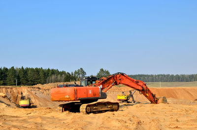 Construction site on field against clear blue sky