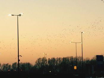 View of street lights against sky during sunset
