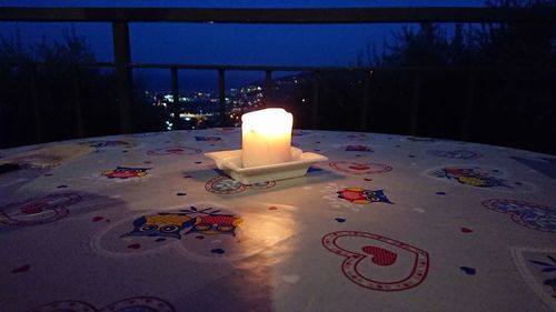 Close-up of illuminated candles on table