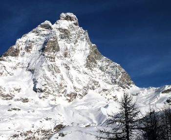 Low angle view of snowcapped mountain against sky