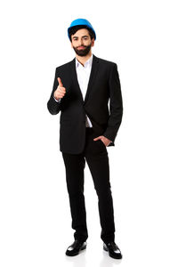 Young man standing against white background