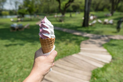 Cropped hand holding ice cream cone