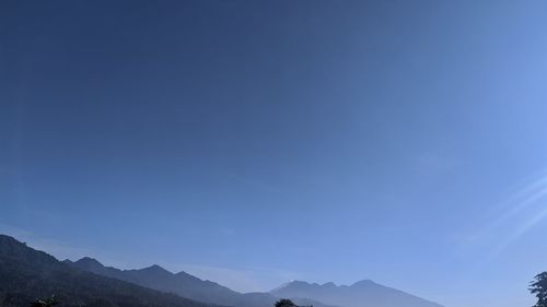 Low angle view of mountains against blue sky