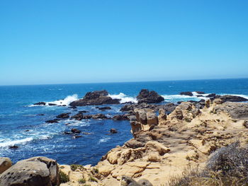 Scenic view of sea against clear blue sky