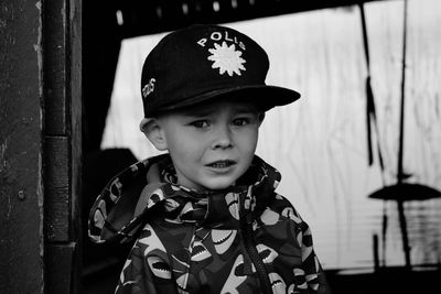 Portrait of boy in halloween costume standing by window