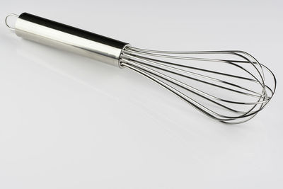 High angle view of metal container on table against white background