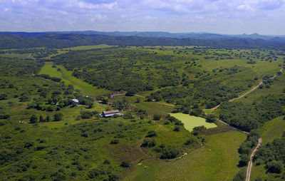 High angle view of green landscape against sky