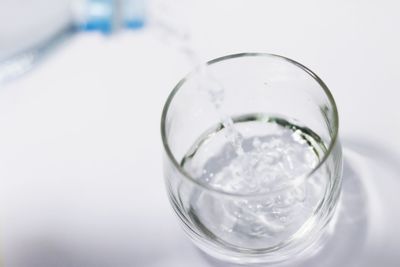 Close-up of water in glass against white background