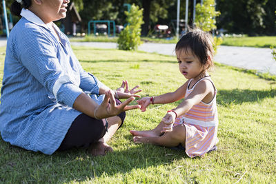 Young woman sitting on field