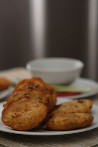 Close-up of bakwan ote ote on plate on table